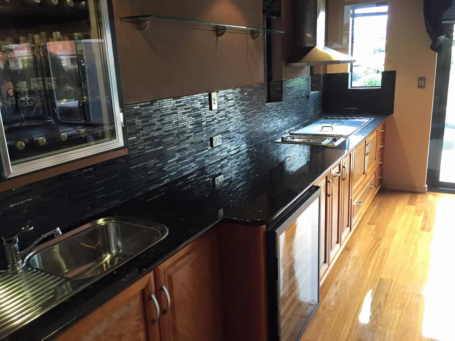 Timber kitchen fit-out with stone benchtops and mosaic splashback
