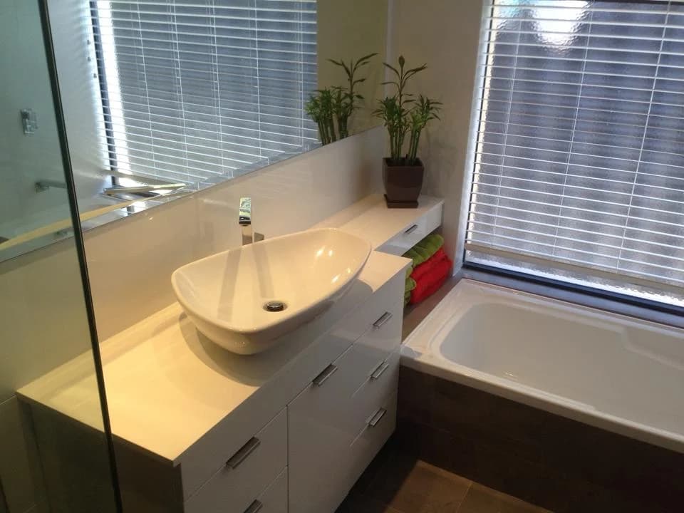 Bright bathroom renovation with vessel basin, floating vanity and bathtub
