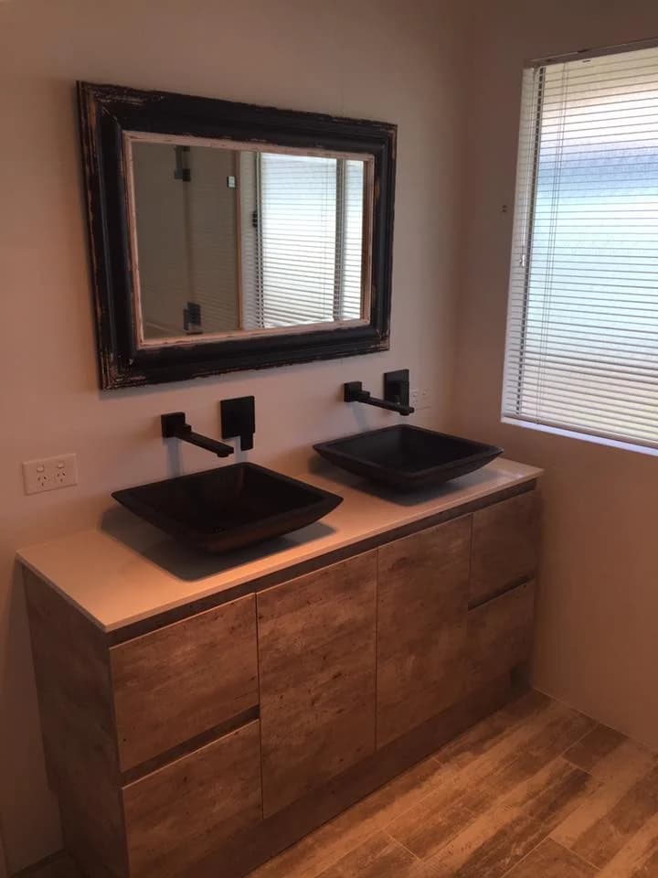Ensuite with twin black vessel basins on a timber vanity
