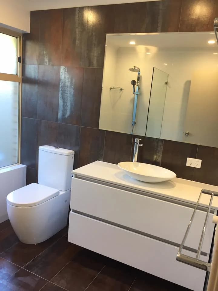 Renovated bathroom with feature wall, floating vanity and walk-in shower
